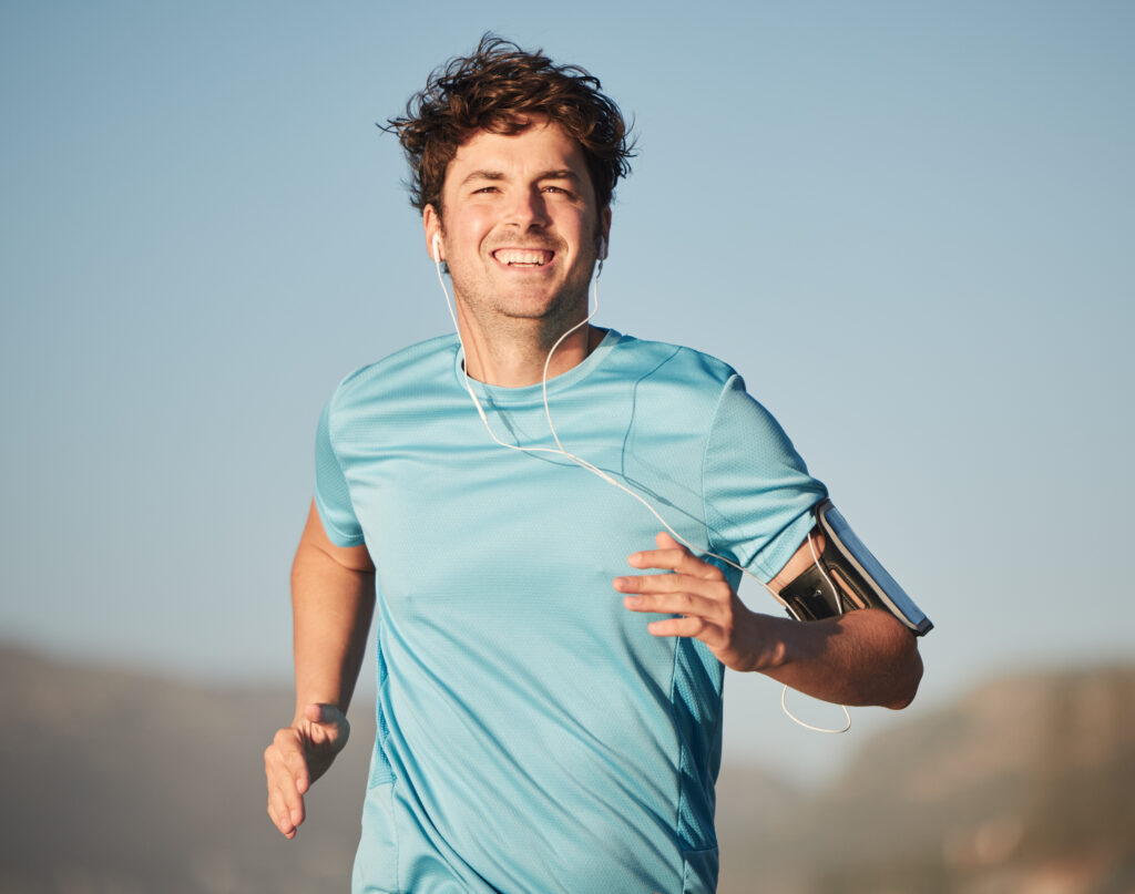 happy-running-man-athlete-with-music-steaming-nature-fitness-training-nature-portrait-happy-healthy-smile-runner-sun-doing-cardio-sports-workout-exercise