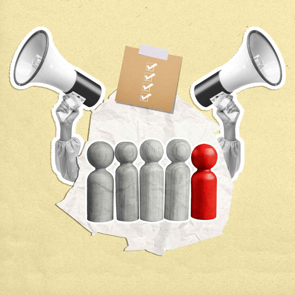 human-hand-holding-megaphone-with-row-wooden-human-figures